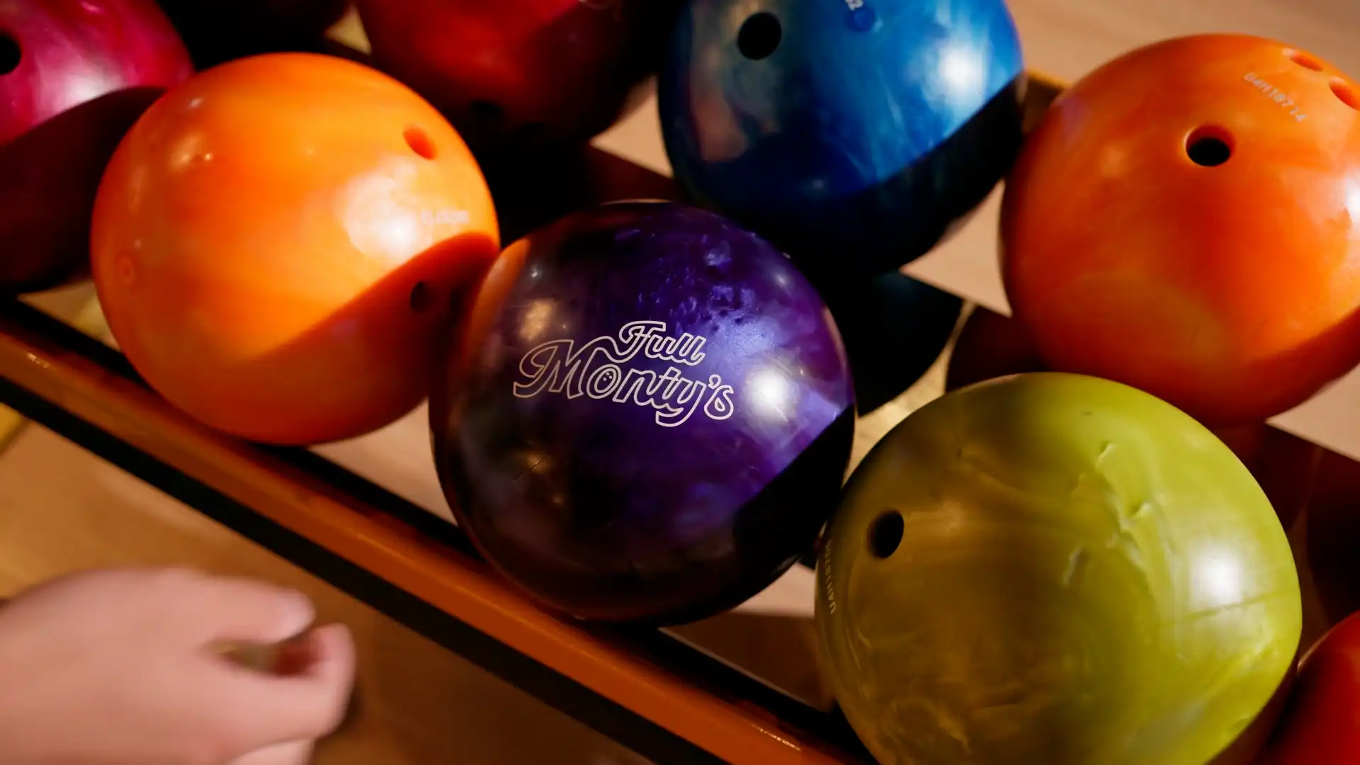 Colourful bowling balls with Full Monty’s logo at Rolleston Christchurch bowling lanes